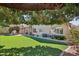 The backyard has a custom BBQ, covered patio, and well-manicured landscaping at 5102 E Libby St, Scottsdale, AZ 85254