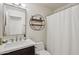 Bathroom features a stylish round wall shelf, granite countertop, and ample lighting at 5102 E Libby St, Scottsdale, AZ 85254