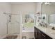 Bathroom featuring shower, soaking tub, quartz countertops and shuttered windows at 5102 E Libby St, Scottsdale, AZ 85254