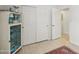 Bright bedroom features closet space, tile floors, and decorative display cabinet at 5102 E Libby St, Scottsdale, AZ 85254