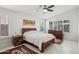 Bright bedroom features wood furnishings, plantation shutters, and neutral color palette at 5102 E Libby St, Scottsdale, AZ 85254