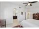 Large bedroom with tile flooring, arched entry to bath, and ceiling fan at 5102 E Libby St, Scottsdale, AZ 85254