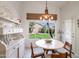 Bright breakfast area with garden view, decorative shelving, and stylish light fixture at 5102 E Libby St, Scottsdale, AZ 85254