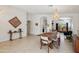 Open-concept dining room with modern lighting, tile floors, and seamless access to living spaces at 5102 E Libby St, Scottsdale, AZ 85254