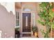 The main house entrance features a decorative glass door, sidelight window, and desert landscaping at 5102 E Libby St, Scottsdale, AZ 85254