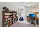 Home office with built-in bookcase, blue beanbag chair, and neutral color palette at 5102 E Libby St, Scottsdale, AZ 85254