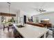 Open-concept kitchen with a large island overlooking the living room and backyard views at 5102 E Libby St, Scottsdale, AZ 85254