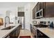 Bright kitchen featuring stainless steel appliances, white countertops, and dark wood cabinetry at 5102 E Libby St, Scottsdale, AZ 85254