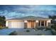 Charming single-story home featuring desert landscaping, a two-car garage, and stone accents on the facade at 5412 W Jackalope Ln, Laveen, AZ 85339