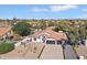 Aerial view of property with desert landscaping, terra cotta tile roof and 2 car garage at 5704 E Estrid Ave, Scottsdale, AZ 85254