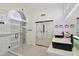 Luxurious bathroom featuring double vanities, an expansive glass shower, and modern fixtures at 5704 E Estrid Ave, Scottsdale, AZ 85254