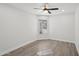 Bright bedroom featuring modern ceiling fan, wood floors and a large window at 5704 E Estrid Ave, Scottsdale, AZ 85254