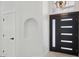 Bright entryway featuring a modern black door with sidelights and an art niche on the adjacent wall at 5704 E Estrid Ave, Scottsdale, AZ 85254