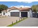 Charming exterior with terra cotta tile roof and 2 car garage at 5704 E Estrid Ave, Scottsdale, AZ 85254