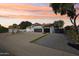 Charming home exterior with desert landscaping, terra cotta tile roof, and extended driveway at 5704 E Estrid Ave, Scottsdale, AZ 85254