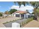 Charming exterior with terra cotta tile roof, black garage doors and driveway at 5704 E Estrid Ave, Scottsdale, AZ 85254
