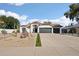 Charming home showcasing beautiful desert landscaping and a spacious driveway at 5704 E Estrid Ave, Scottsdale, AZ 85254