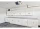 Spacious garage featuring ample white cabinetry and workspace, perfect for storage and projects at 5704 E Estrid Ave, Scottsdale, AZ 85254