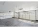 Spacious three car garage features abundant cabinet space and epoxy flooring at 5704 E Estrid Ave, Scottsdale, AZ 85254