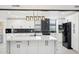 Modern kitchen with large island, black stainless appliances, and marble backsplash at 5704 E Estrid Ave, Scottsdale, AZ 85254