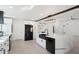 Stylish kitchen featuring an island with a farmhouse sink, white cabinets, and modern black appliances at 5704 E Estrid Ave, Scottsdale, AZ 85254