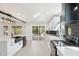 Contemporary kitchen with white cabinetry, black hardware, and sleek black countertops at 5704 E Estrid Ave, Scottsdale, AZ 85254