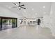 Bright living room with a vaulted ceiling, leading into the kitchen and offering access to the backyard at 5704 E Estrid Ave, Scottsdale, AZ 85254