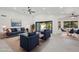 Bright living room features high ceilings, stylish furniture, sliding glass doors, and modern ceiling fan at 5704 E Estrid Ave, Scottsdale, AZ 85254