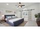 Bright main bedroom boasts a ceiling fan, modern fixtures, and a unique arched entry to the ensuite bathroom at 5704 E Estrid Ave, Scottsdale, AZ 85254