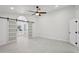 Bright main bedroom with barn doors leading into ensuite bathroom at 5704 E Estrid Ave, Scottsdale, AZ 85254
