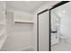 Well-organized walk-in closet with ample shelving, a hanging rod, and access to a stylish bathroom at 5704 E Estrid Ave, Scottsdale, AZ 85254