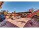 Outdoor patio surrounded by lush flowering bushes and a wooden fence at 5905 N 83Rd St, Scottsdale, AZ 85250