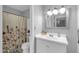 Clean bathroom with a single vanity, decorative shower curtain, and well-lit mirror at 5905 N 83Rd St, Scottsdale, AZ 85250