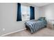 Cozy bedroom with a comfortable bed and ample natural light from the large window at 5905 N 83Rd St, Scottsdale, AZ 85250