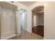 Modern bathroom with glass-enclosed shower and tile flooring with open access to bedroom area at 62 N Amber Ct, Chandler, AZ 85225