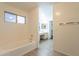 Bathroom featuring a bathtub and vanity, with natural light coming through the window at 62 N Amber Ct, Chandler, AZ 85225