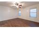 Comfortable bedroom featuring wood floors, a ceiling fan, and bright windows at 62 N Amber Ct, Chandler, AZ 85225