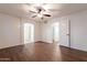 Cozy bedroom with wood floors, access to the bathroom and closet, and a ceiling fan at 62 N Amber Ct, Chandler, AZ 85225