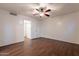 Bright bedroom featuring wood floors, a ceiling fan, and an entrance to the bathroom at 62 N Amber Ct, Chandler, AZ 85225
