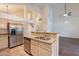 Contemporary kitchen featuring stainless steel appliances, tile backsplash, and granite countertops at 62 N Amber Ct, Chandler, AZ 85225