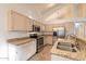 Bright kitchen with stainless steel appliances, granite counters, tile floors, and plentiful cabinet space at 62 N Amber Ct, Chandler, AZ 85225