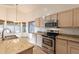 Well-equipped kitchen featuring stainless steel appliances, granite countertops, and ample cabinet space at 62 N Amber Ct, Chandler, AZ 85225