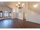 Inviting living room with hardwood floors, arched windows, and staircase, offering a spacious, light-filled area at 62 N Amber Ct, Chandler, AZ 85225