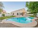 Backyard with a refreshing blue pool, lush lawn, and covered patio, perfect for outdoor living at 62 N Amber Ct, Chandler, AZ 85225
