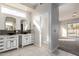 Modern bathroom with dual sinks, stylish mirrors, and access to the bedroom and bathroom at 730 E Tanya Trl, Phoenix, AZ 85086