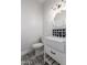 Charming half bath with stylish black and white tile flooring, sink and toilet at 730 E Tanya Trl, Phoenix, AZ 85086