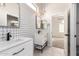 Stylish bathroom featuring dual sinks, white vanities, tile backsplash and modern fixtures at 730 E Tanya Trl, Phoenix, AZ 85086
