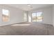 Carpeted bedroom with natural light, featuring a sliding glass door leading to the outside at 730 E Tanya Trl, Phoenix, AZ 85086