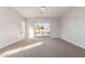 Bright carpeted bedroom with a view of the backyard and pool through sliding glass doors at 730 E Tanya Trl, Phoenix, AZ 85086