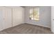 Bedroom with neutral carpet, a large window and a closet with sliding doors at 730 E Tanya Trl, Phoenix, AZ 85086